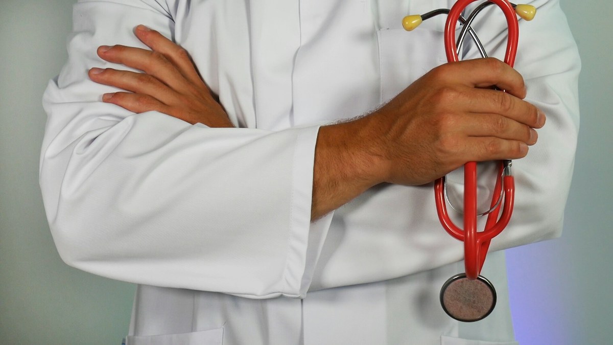 Physician standing with a stethoscope